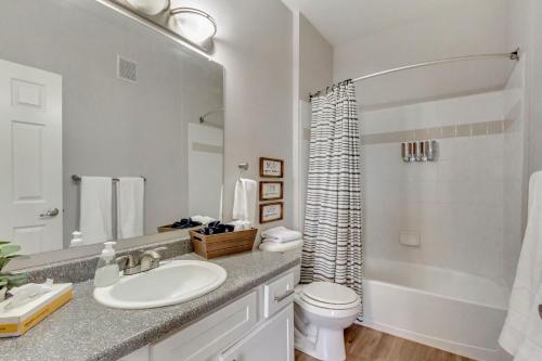 a bathroom with a sink and a toilet and a tub at Mountain View by Cloud Dream Homes in Clearfield