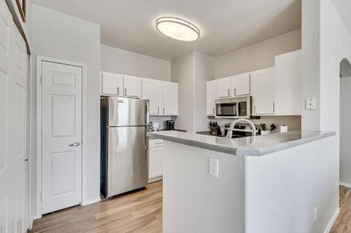 a kitchen with white cabinets and a stainless steel refrigerator at Mountain View by Cloud Dream Homes in Clearfield
