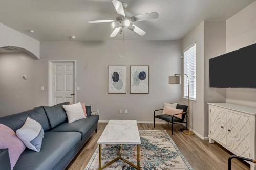 a living room with a blue couch and a flat screen tv at Mountain View by Cloud Dream Homes in Clearfield