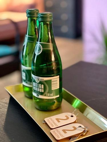 two bottles of beer sitting on a tray at Restauracja Pałacowa Apartamenty in Radzyń Podlaski