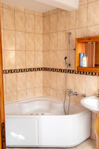 a bath tub in a bathroom with a sink at Old Town Villa Sarajevo in Sarajevo