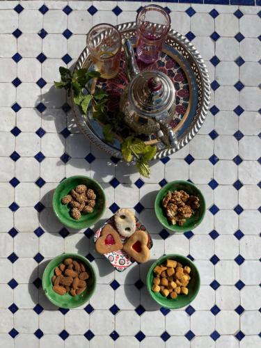 a table topped with plates of food on a table at Dar Mgouna Roses in Kalaat MGouna