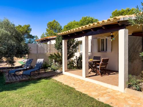 a patio with chairs and a table in a backyard at Can Pep Yern 3 in Playa Migjorn
