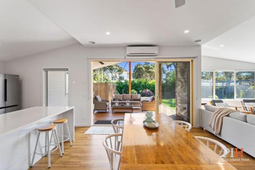 a kitchen and living room with a wooden table at Renovated Lux Property in Quiet Estate in Cowes