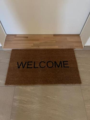 a welcome mat on the floor in a room at Zentrales Apartment St Gallen in St. Gallen