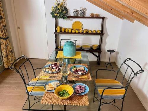 a table with plates of food and a blue pot on it at Casa Larius in Como