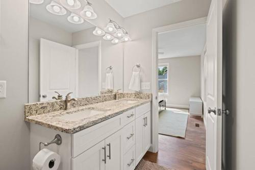 a bathroom with a sink and a large mirror at Water,Power,WIFI- 10 Min to Downtown AVL in Asheville
