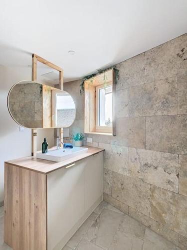 a bathroom with a sink and a mirror at Le Barral in Voiron