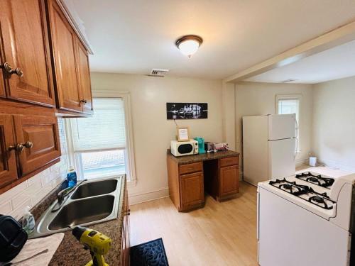 a kitchen with a white refrigerator and a sink at Nice bedroom in Lincoln with shared bathroom 1 in Lincoln