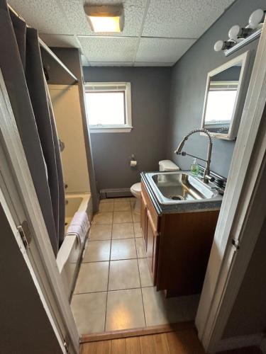 a bathroom with a sink and a toilet at Spacious one bedroom apartment near Whole Foods, Brown University 22F in Providence