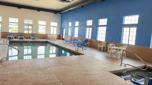 a pool with chairs and tables in a large room at Comfort Inn in Santa Fe