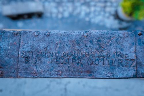 a metal sign with writing on it on a street at Casa 1800 Oaxaca Boutique Hotel City Center based in Oaxaca City