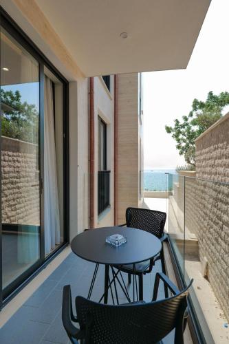 a patio with a table and chairs on a balcony at DAED Luxury Residence in Sarandë