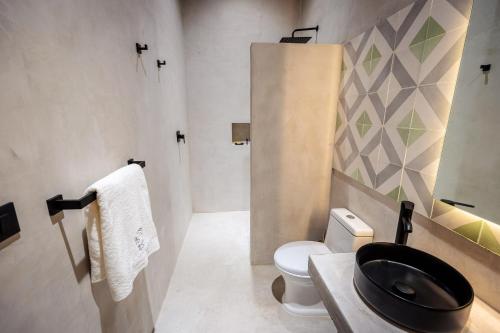 a bathroom with a black toilet and a sink at Casa 1800 Oaxaca Boutique Hotel City Center based in Oaxaca City