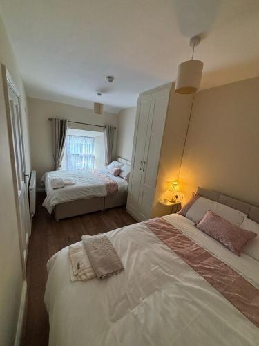 a bedroom with two beds and a window at The Shebeen Apartment2 in Ballina