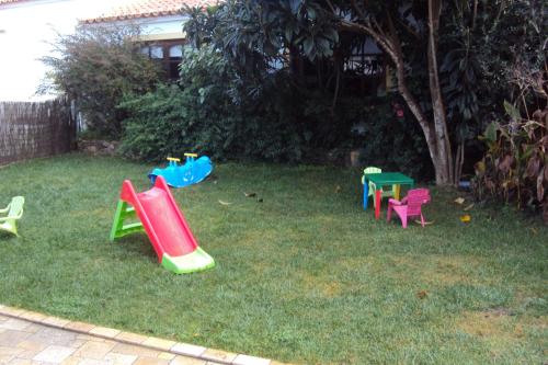 a group of childrens play equipment in the grass at Casa Antiga in Odeceixe