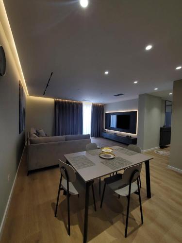 a living room with a table and a couch at DAED Luxury Residence in Sarandë