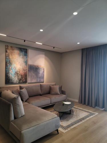 a living room with a couch and a table at DAED Luxury Residence in Sarandë