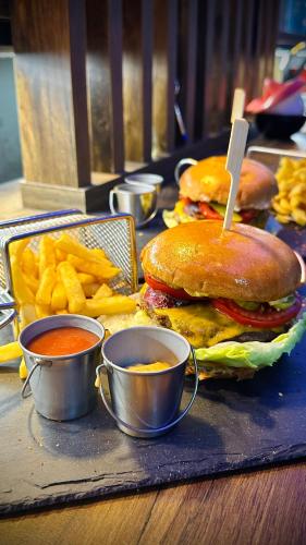 a tray with a hamburger and french fries and dipping sauce at Intermezzo2 in Prijepolje