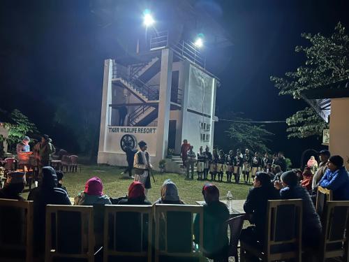 a crowd of people watching a performance at night at Tiger Wildlife Resort in Bharatpur