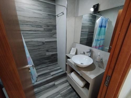 a bathroom with a sink and a mirror at Canning Park premium apartment for 4 in Canning