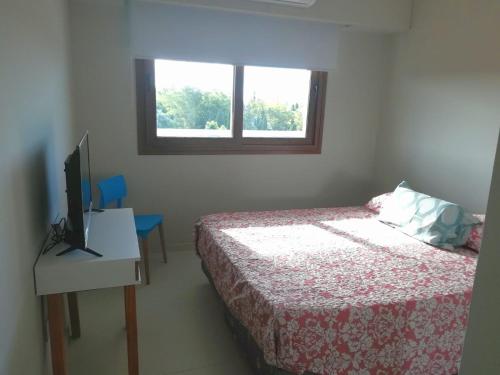 a bedroom with a bed and a tv and a window at Canning Park premium apartment for 4 in Canning