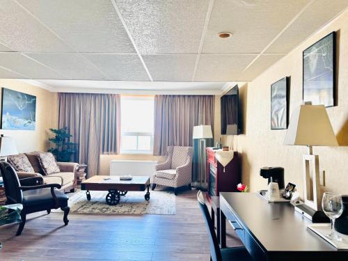 a living room with a couch and chairs and a table at Travelodge by Wyndham Prince Albert in Prince Albert