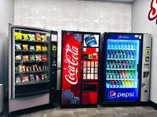 two soda machines in a store with soda bottles at Travelodge by Wyndham Prince Albert in Prince Albert
