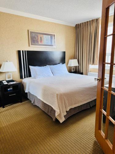 a hotel room with a large bed and two lamps at Travelodge by Wyndham Prince Albert in Prince Albert