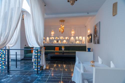 a room with white curtains and a display of items at Riad L'ECOLE in Marrakech