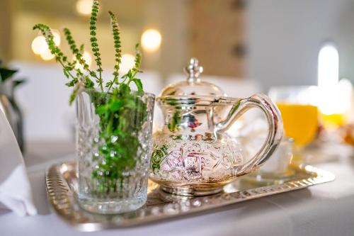 a glass pitcher and a vase on a table at Riad L'ECOLE in Marrakech