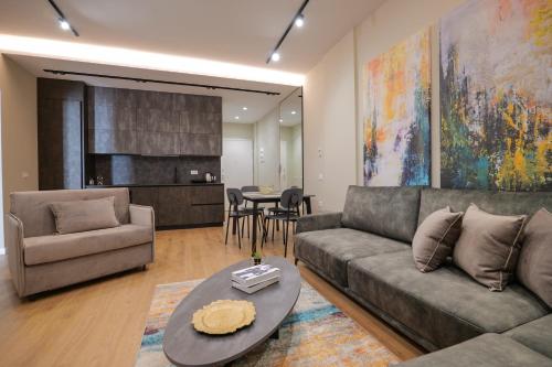 a living room with a couch and a table at DAED Luxury Residence in Sarandë