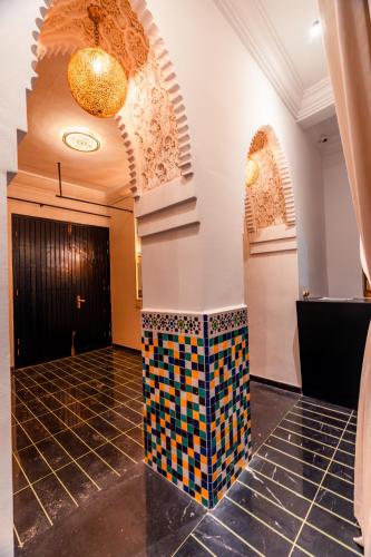 a lobby with a colorful tile floor in a building at Riad L'ECOLE in Marrakech