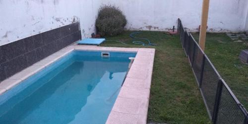 a swimming pool in a yard next to a fence at charly in San Luis