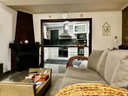 a living room with a couch and a table at Love, made in xisto in Piódão