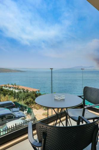 a patio with a table and chairs and the ocean at DAED Luxury Residence in Sarandë