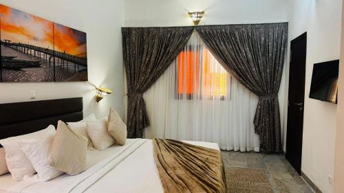 a bedroom with a large bed and a window at Hotel Dior in Saint-Louis