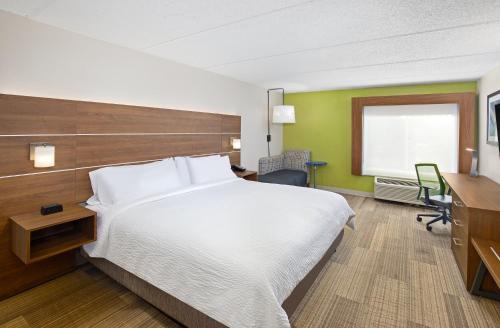 a hotel room with a large bed and a desk at Holiday Inn Express & Suites Kings Mountain - Shelby Area by IHG in Kings Mountain