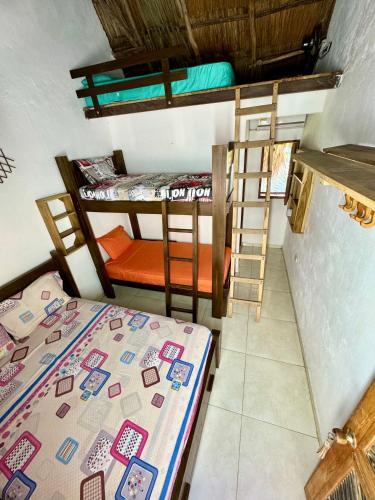 a room with two bunk beds and a bed at Hostal Nibuni Palomino in Palomino