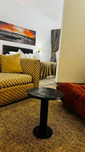 a living room with a couch and a table at Hotel Dior in Saint-Louis