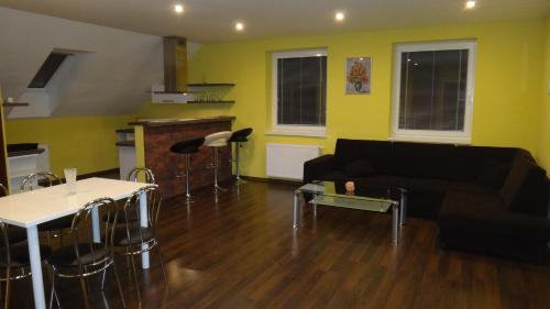 a living room with a couch and a table at Penzión Melódia in Kanianka