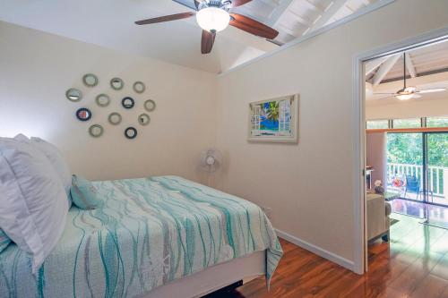 a bedroom with a bed and a ceiling fan at Paniolo 210B in Princeville
