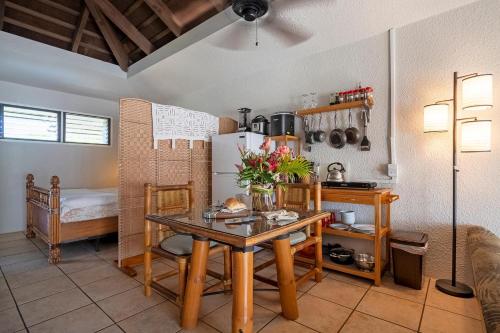 a kitchen with a table and a refrigerator at Paniolo 204B in Princeville