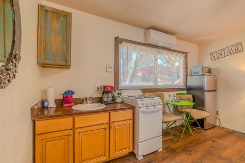 a kitchen with a sink and a stove and a refrigerator at Enchanted Hideaway Cabins and Cottages in Ruidoso