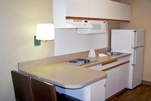a small kitchen with a sink and a refrigerator at MainStay Suites Las Vegas Convention Center in Las Vegas