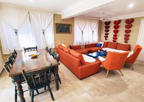 a living room with a couch and a table at Big family holiday by the Buddina beach in Buddina