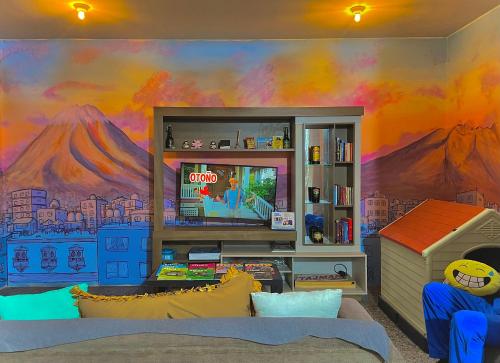 a living room with a mural of a mountain at Peru Hostel Tajmani in Arequipa