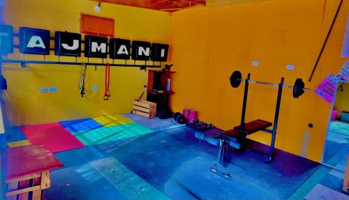 a room with a gym with a sign on the wall at Tajmani Hostel Arequipa in Arequipa