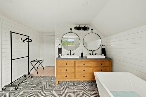 a bathroom with two sinks and a mirror at Classic Country 6 Bedroom in Kingston