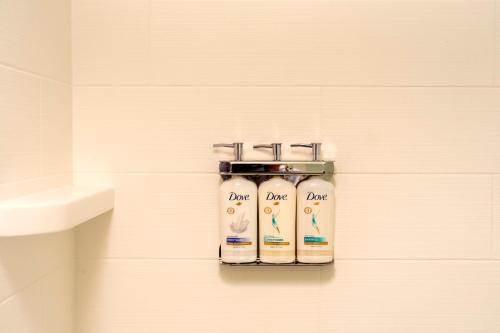 a bathroom with two bottles of soap on a wall at Holiday Inn Express Athens - University Area by IHG in Athens